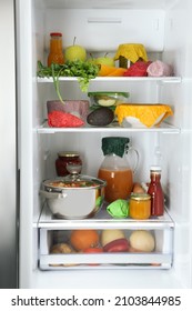 Open Refrigerator With Many Different Products Packed In Beeswax Food Wraps