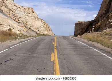 Open Road Heading Up Hill In The Mountains.