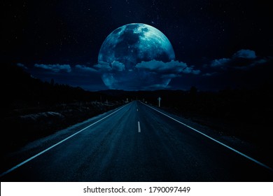 Open road of night sky with clouds and moonlight. Elements of this image furnished by NASA. - Shutterstock ID 1790097449