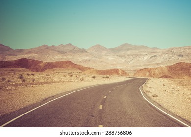 Open Road and possibilities. Road in Death Valley National Park. Artistic Instagram style processing.