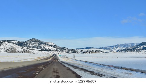 Open road through Montana's beautiful landscape of plains and mountains - Shutterstock ID 1299786889