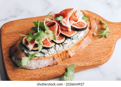 Open Sandwich with Blue Cheese, Figs, Rocket salad leaves and Prosciutto - Shutterstock ID 2226614927