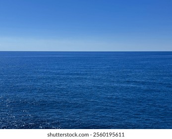 Open sea blue calm water and cloudless sky. - Powered by Shutterstock