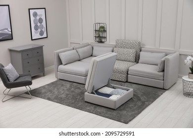 Open Section With Storage Near Modular Sofa In Living Room. Interior Design