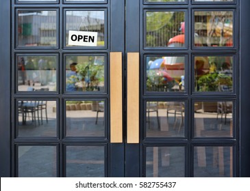 Open Sign Board Hanging On Door Of Cafe.