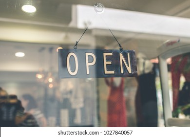 Open sign broad through the glass of store window. Asia. - Shutterstock ID 1027840057