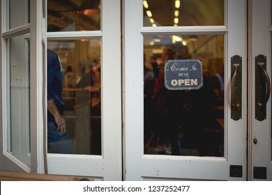 Open Signboard On A Coffee Shop Door With A White Wooden Frame. Landscape Format.