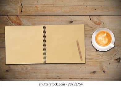 Open Sketch Book, Pencil And Latte Art On Wooden Table