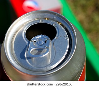 Open soda can with liquid drops on top