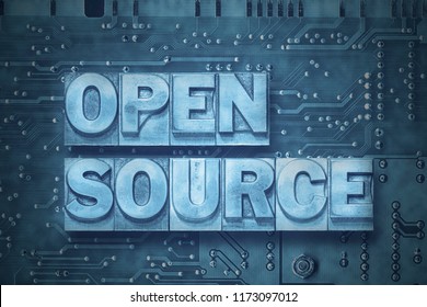 open source phrase made from metallic letterpress blocks on the pc board background