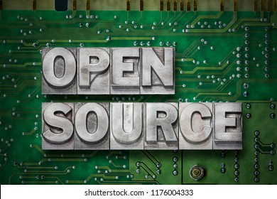 open source phrase made from metallic letterpress blocks on the pc board background