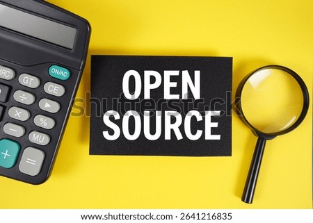 Open Source text with magnifying glass anc calculator on yellow background