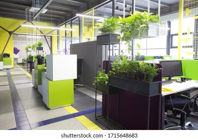 Open space interior with green plants and places for workers, no people, quarantine time, copy space - Powered by Shutterstock