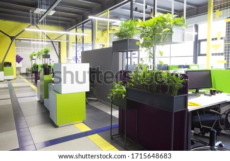 Open space interior with green plants and places for workers, no people, quarantine time, copy space