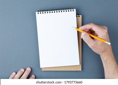 Open spiral notebook with clear page and male hands with yellow pencil on blue background. Design business, office supplies or education concept. Ready for adding or mock up. Top view. - Shutterstock ID 1793773660