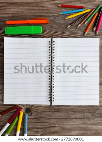 Open Spiral Notebook With Large Copy Space And Stationery On Wooden Desk Background