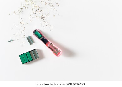 Open Stapler With Colored Staples. Flat Lay, Top View. Feminine Office Concept.