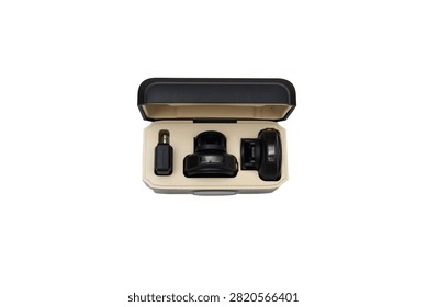 Open storage and charging case containing a portable wireless lavalier microphone system, isolated on a white background.
