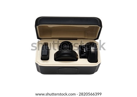 Open storage and charging case containing a portable wireless lavalier microphone system, isolated on a white background.