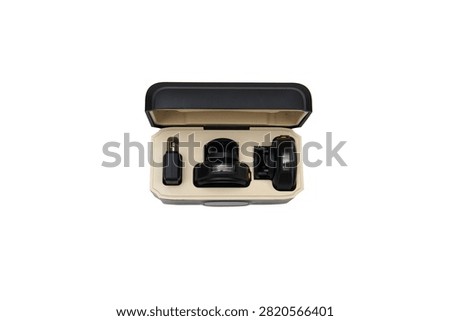 Open storage and charging case containing a portable wireless lavalier microphone system, isolated on a white background.