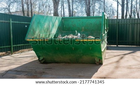Open street dumpster is deposit or dispose of garbage waste or unwanted material typically in a careless or hurried way.