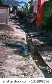 Open Street Sewerage Combined With Running Water Drain. Drainage Structures Make On Back Streets, Dirty Street. Countries Of South-East Asia. Unsanitary Living Conditions, Poor Sanitation