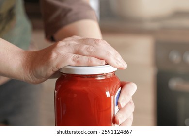 Open Stuck Jar. Problem when working with tightly closed Jars with Pickled. Woman Opening Glass Jar with preserved tomatoes