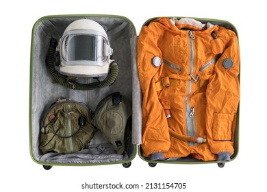 Open suitcase packed for space travelling with astronaut orange space suit, space helmet and spacesuit accessories isolated on white background. Top view. Fun space tourism concept.