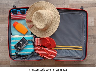 Open suitcase packed for travelling, close up - Shutterstock ID 542685802