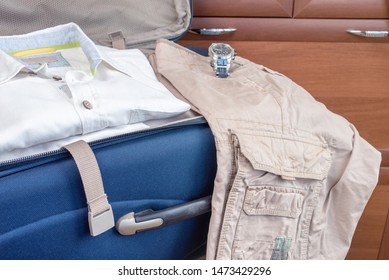 An open suitcase with a shirt and shorts. Going on vacation. Concept. - Shutterstock ID 1473429296