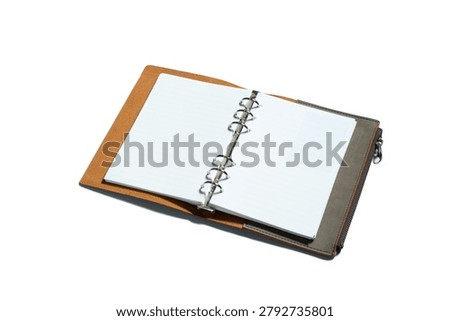 An open tan and gray leather ring binder organizer with silver rings and zipper closure, isolated on white, ideal for office and stationery product concepts.