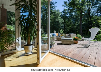 Open terrace doors, in the background outdoor furniture set