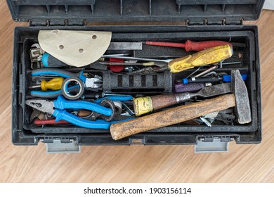 An Open Tool Box Photographed From Above With Many Different Tools In It.