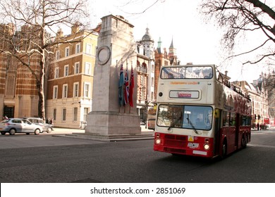 an open topped tour bus drives past the cenotaph in Whitehall in Central London, slight motion blur on the tour bus