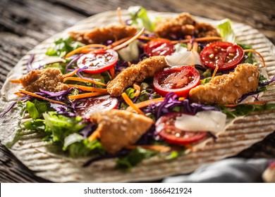 Open Tortilla With Chicken Nuggets, Chery Tomatoes, Red Cabbage, Salad, Carrot Stripes And Parmesan Shavings.