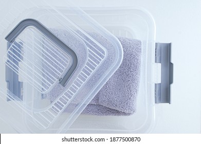 Open Transparent Plastic Box With Storage Container Lid. White Background.