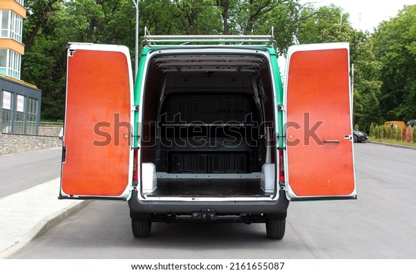 Open\
trunk of a modern cargo van. Rear view of a modern cargo van\
vehicle with open trunk and loading\
compartment.