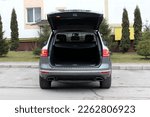 Open trunk of a modern SUV. SUV open trunk. Modern SUV clean trunk. Rear view offroad car with open trunk.