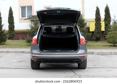 Open trunk of a modern SUV. SUV open trunk. Modern SUV clean trunk. Rear view offroad car with open trunk.