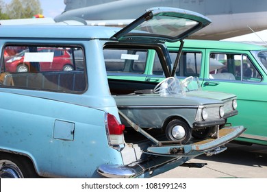 In The Open Trunk Of The Old Station Wagon Are Toy Cars.