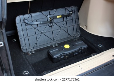 Open Trunk Of SUV Car With Tool Box. Car Tools In Opened Trunk Door. Emergency Car Tool Box Lying In The Trunk.