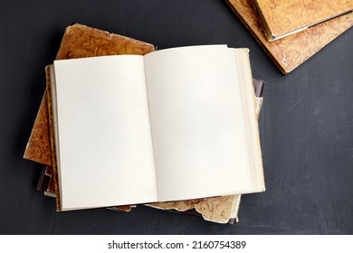 Open Vintage Book Or Notebook In A Dust Jacket On A Stack Of Old Shabby Books