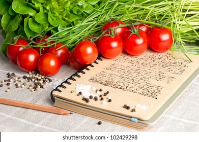 Open Vintage Cook Book  With Old Recipe Text. Vegetables Tomato, Chives And Spices