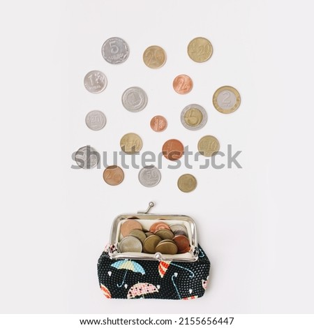 Open wallet with different coins isolated on white background top view. Financial crisis, poverty, lack of money concept