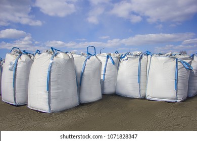 open warehouse of big bags against the blue sky and clouds.