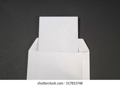 Open White Paper Envelope On The Black Background