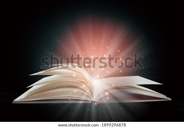 Open white\
paper fantasy book with shining pages isolated on black background.\
Miracle concept and mystery\
idea