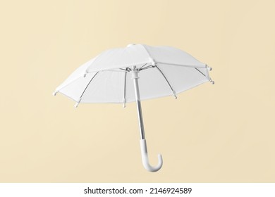 Open white umbrella on color background