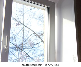 An Open Window In The Children's Room In Winter With Paper Snowflakes Pasted On The Glass.