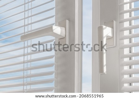 Open window. PVC plastic. Louver blinds.